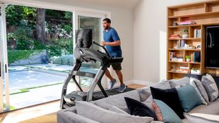 Man running on a treadmill at home