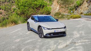 Front on, at an angle, view of Kia EV6 parked in a layby in the mountains