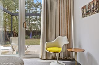 colourful views of michigan's modernist, single storey Frost House with large openings towards nature