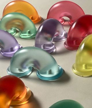 Colourful translucent door handles by Sam Stewart in yellow, green, orange, red and blue