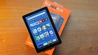 An Amazon Fire HD 8 Plus best cheap tablet with its screen on, resting on its box