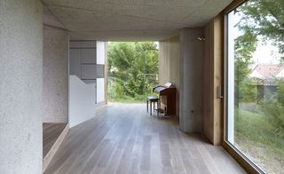 Piano in a large open plan room looking out to open gardens