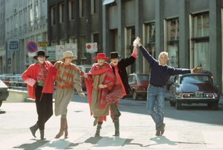 Giorgio Armani with fashion models in a Milan street, in 1982