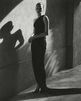 Model wears black against backdrop of Moroccan hotel