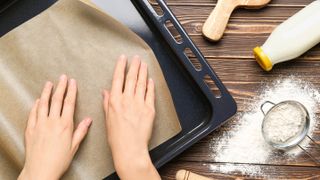 Baking parchment being placed on a tray