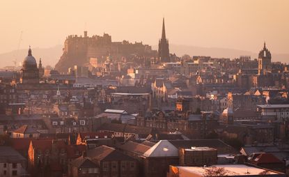 Looking over the rooftops towards Edinburgh Castle during a warm evening glow