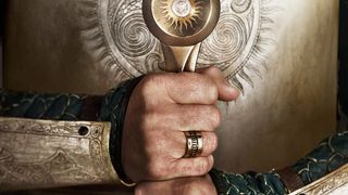 a close-up of hands gripping the base of a sword in a character poster for The Lord of the Rings: The Rings of Power