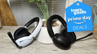 A pair of Sony Inzone H5 wireless gaming headsets in white and black sitting on a light brown table.