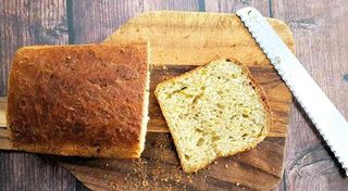 Loaf of homemade zucchini bread sliced on a bread board