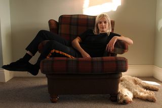 Living Room with sofa chair woman and dog