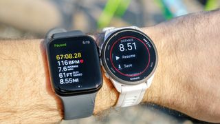 Apple Watch SE 2022 on the wrist next to a Garmin Forerunner 165.