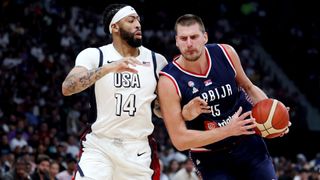 Nikola Jokic (R) all in blue, takes on Anthony Davis (L), in all white, ahead of Serbia vs USA in the men&#039;s basketball at the 2024 Olympic Games.