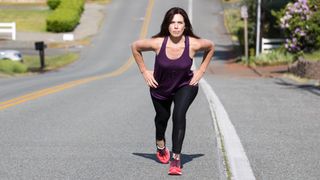 a photo of a woman walking up hill