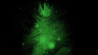 a gaseous green nebula in the shape of a christmas tree