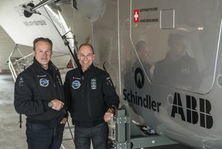 Andre Borschberg & Bertrand Piccard Pose with Solar Impulse 2 Plane