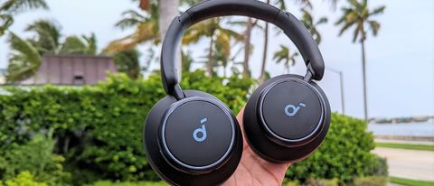 Anker Soundcore Space Q45 headphones placed in reviewer&#039;s hand with outdoors Florida scene in background