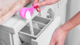 Whitener being tipped into the dispenser of a washing machine