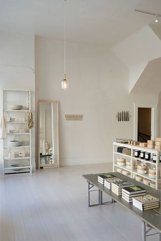 white shop with books and items on shelf