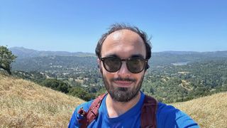 The author (Michael Hicks) taking a selfie on top of a hiking trail.