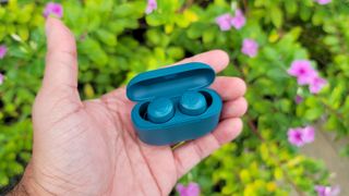 Listing image for the best cheap earbuds showing the JLab Go Air Pop held in hand