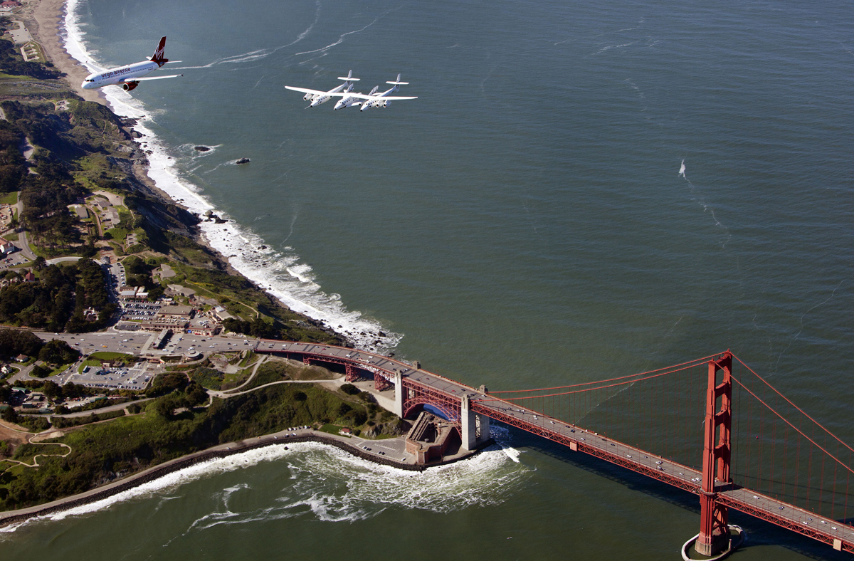 Virgin Galactic&#039;s private SpaceShipTwo spacecraft and its mothership WhiteKnightTwo flies over the Golden Gate Bridge with the Virgin America plane &quot;My Other Ride is a Spaceship&quot; on April 6, 2011 en route to open Terminal 2 at San Francisco International 