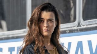 Cote de Pablo's Ziva David standing near a bus in NCIS