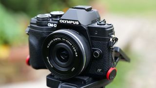 Olympus OM-D E-M10 Mark IV, one of the best camera for beginners, on a tripod