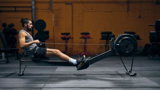 A man exercising on one of the best rowing machines