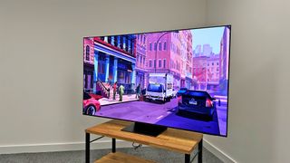 Samsung S95C on a TV stand in our testing room