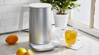 A silver Zwilling kettle next to lemon tea