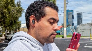 Man wearing Skullcandy Dime 3 earbuds outside