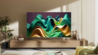 Hisense U6N TV on a wooden media unit in front of a beige wall. On screen is a wavy graphic in green and gold.