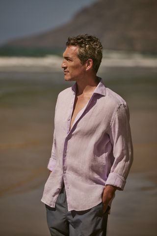 Man in Luca Faloni linen shirt on beach