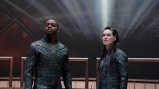 Stephan James (L) as Halan and Lena Heady (R) as Aster stand in front of the backdrop of space in &quot;Beacon 23&quot; season 2