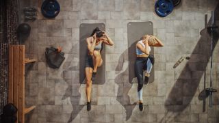 a photo of two women doing the ab bicycle exercise