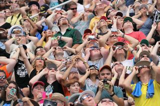 People watch the solar eclipse at Saluki Stadium on the campus of Southern Illinois University in Carbondale, Illinois, on Aug. 21, 2017. 
