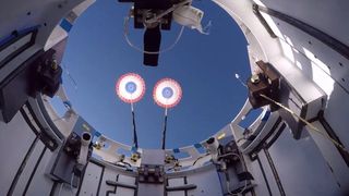 view of parachutes deploying above a spacecraft