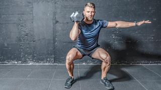 a photo of a man performing an overhead dumbbell press