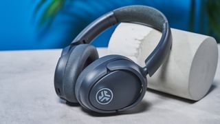 a pair of graphite gray headphones by JLab with 3 buttons