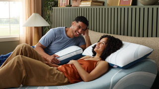 A man and woman in bed lying on the Tempur-Pedic Adapt pillow