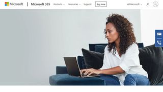 Woman sitting on couch using laptop