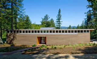 Clad in cedar, the house is topped off with a metal roof