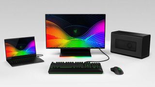 A collection of Razer gaming devices, including laptop, monitor, keyboard and mouse.