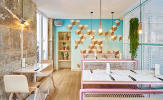 Exposed stone mixed with patterned paintings and display shelves with pot plants