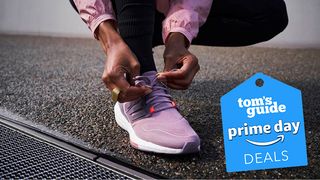 Close up of person tying up Adidas Ultraboost trainers outdoors with Prime Day badge bottom right corner