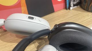 A close up of the Sonos Ace and Apple AirPods Max buttons