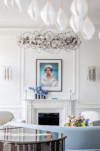 Sofa, piano and fireplace and chandelier in House of Walpole London interiors