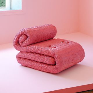 A pink folded mattress made into a chair by a finalist of Design Parade 2024 shown in Hyeres