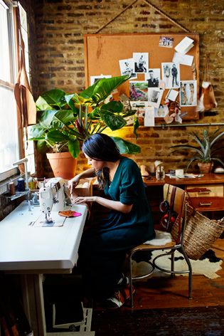 Aurora James tracing patterns onto leather in her Brooklyn studio