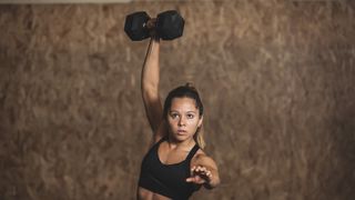 Woman doing a dumbbell snatch